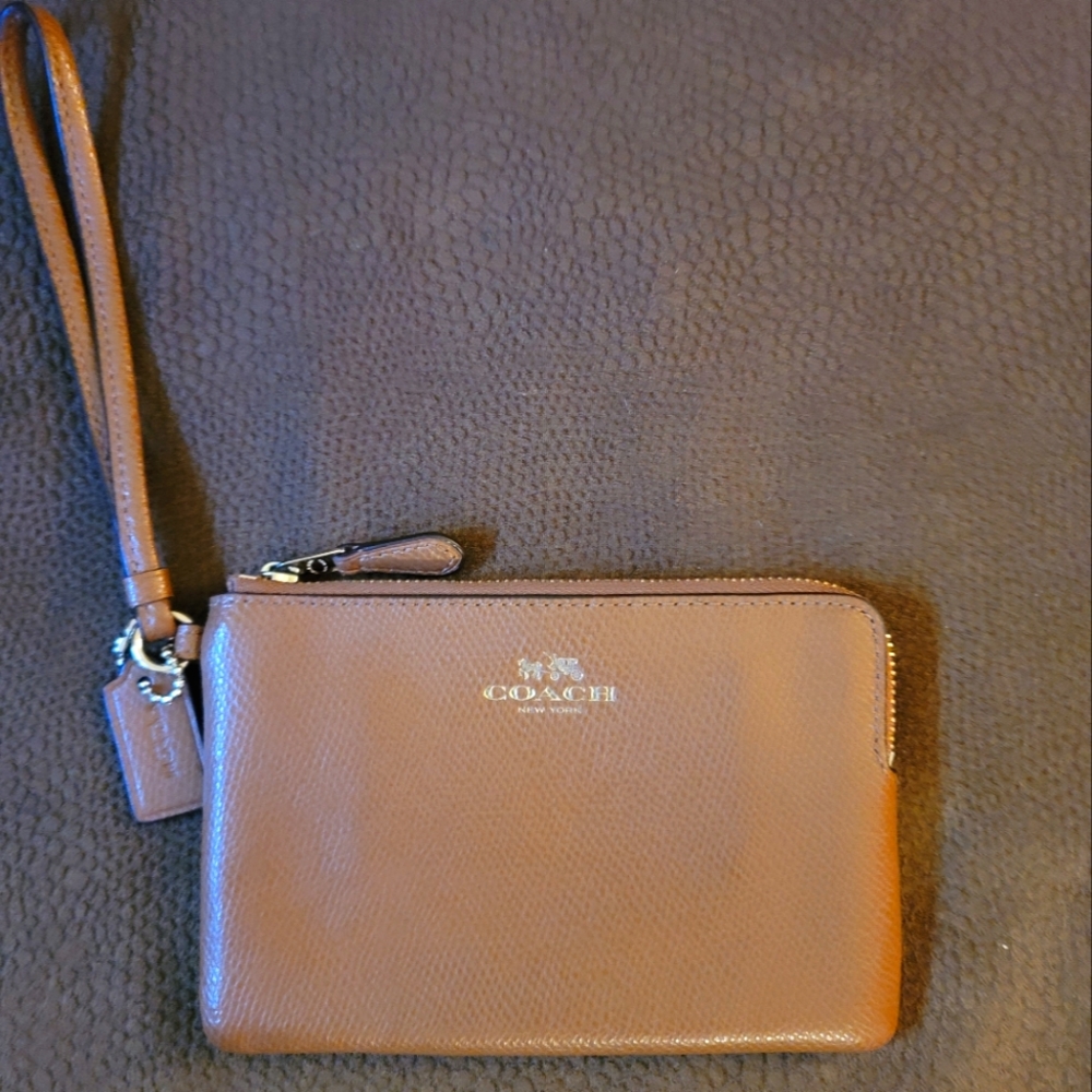 GUC. Coach wristlet, tan with gold accent.